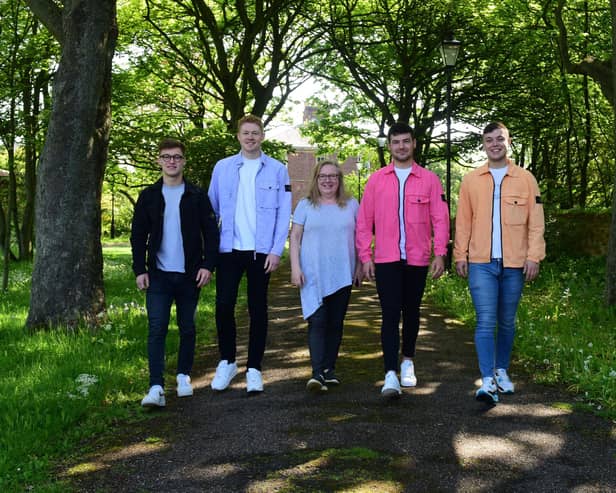 Angie Angus (centre) of Mental Health Concern, with four lads who have raised over £3000 for the charity, l-r Ethan Proud,Ben Robson, Nathan Johnson and Matthew Foster.