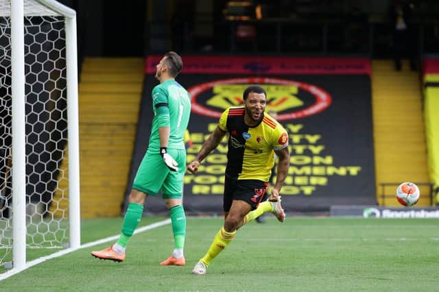 Watford's English striker Troy Deeney (R) celebrates after he scores takes a penalty and scores his team's second goal past Newcastle United's Slovakian goalkeeper Martin Dubravka during the English Premier League football match between Watford and Newcastle at Vicarage Road Stadium in Watford, north of London on July 11, 2020.