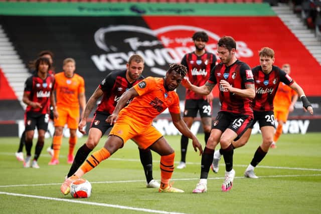 BOURNEMOUTH, ENGLAND - JULY 01: Allan Saint-Maximin of Newcastle United holds off Adam Smith of Bournemouth during the Premier League match between AFC Bournemouth and Newcastle United at Vitality Stadium on July 01, 2020 in Bournemouth, England.