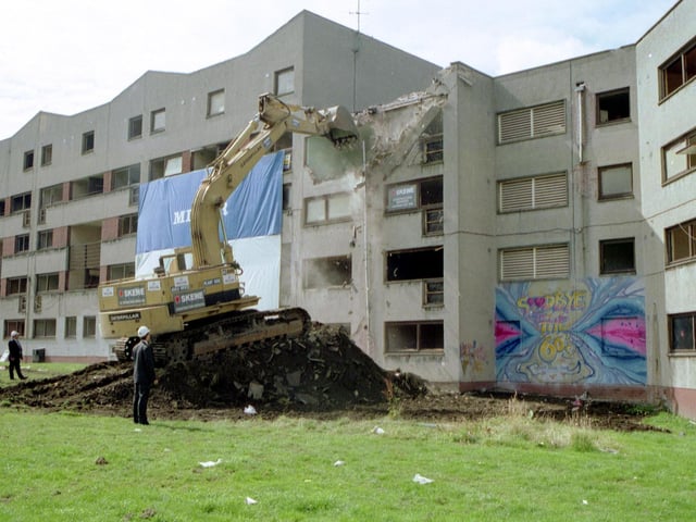 A bulldozer starts the demolition of flats at Granton, August 1992.