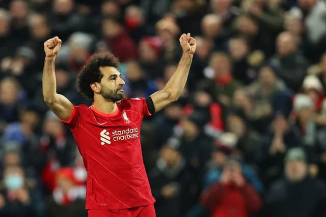 Mohamed Salah of Liverpool celebrates after scoring their side's first goal from the penalty spot during the Premier League match between Liverpool and Aston Villa at Anfield on December 11, 2021 in Liverpool, England. (Photo by Clive Brunskill/Getty Images)