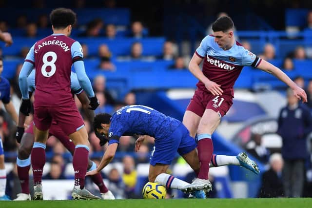 West Ham United's English midfielder Declan Rice (R) tackles Chelsea's Spanish midfielder Pedro during the English Premier League football match between Chelsea and West Ham United at Stamford Bridge in London on November 30, 2019.