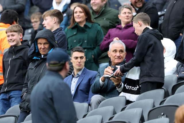 Brazil manager Tite signs an autograph at St James's Park.