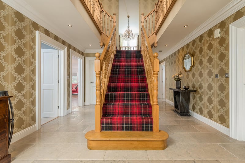 Upon entering the property, the impressive main hallway showcases an oak staircase with tiled flooring throughout.