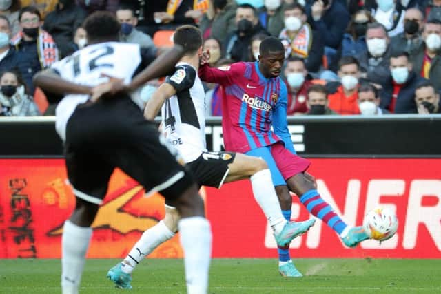 Barcelona's French forward Ousmane Dembele (R) vies with Valencia's Spanish defender Jose Gaya Pena during the Spanish league football match between Valencia CF and FC Barcelona at the Mestalla stadium in Valencia on February 20, 2022. (Photo by JOSE JORDAN / AFP) (Photo by JOSE JORDAN/AFP via Getty Images)