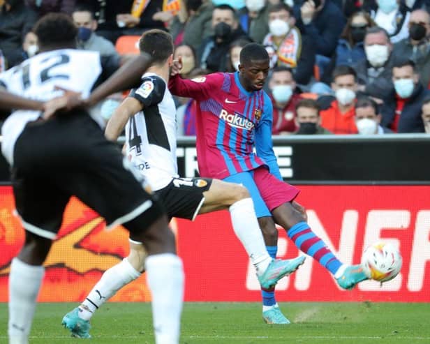 Barcelona's French forward Ousmane Dembele (R) vies with Valencia's Spanish defender Jose Gaya Pena during the Spanish league football match between Valencia CF and FC Barcelona at the Mestalla stadium in Valencia on February 20, 2022. (Photo by JOSE JORDAN / AFP) (Photo by JOSE JORDAN/AFP via Getty Images)