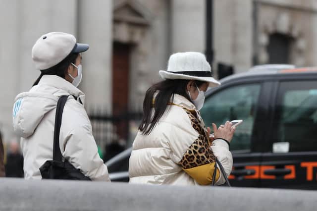 Two women walk through London's Trafalgar Square wearing protective facemasks on the day that Heath Secretary Matt Hancock said that the number of people diagnosed with coronavirus in the UK has risen to 51. Photo credit: Luciana Guerra/ PA Wire