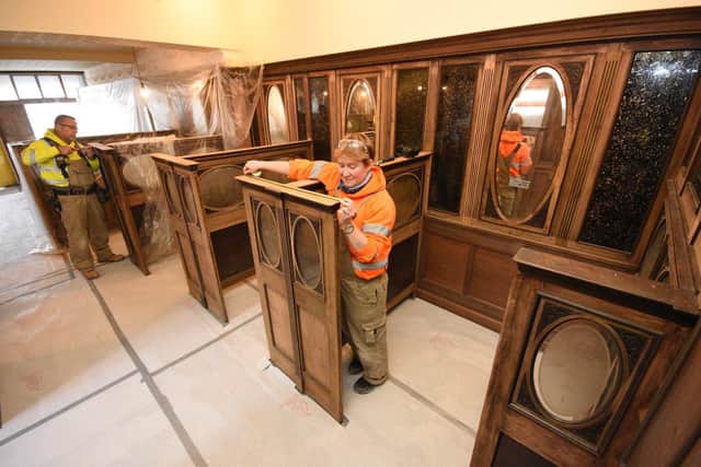 Beamish Team Leader of Joinery, Shawn Kay and joiner Tory Mills apply the finishing touches to the 1950,s booths at John's Cafe.