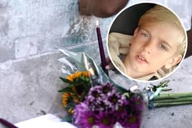 Archie Battersbee, inset, died on Saturday, August 6 after his treatment was withdrawn. Candles have been lit and flowers have been left outside the Royal London Hospital in Whitechapel. Pictures: Hollie Dance/PA.