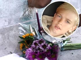 Archie Battersbee, inset, died on Saturday, August 6 after his treatment was withdrawn. Candles have been lit and flowers have been left outside the Royal London Hospital in Whitechapel. Pictures: Hollie Dance/PA.