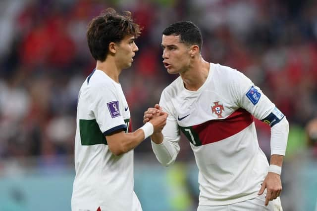 Cristiano Ronaldo of Portugal speaks with Joao Felix of Portugal during the FIFA World Cup Qatar 2022 quarter final match between Morocco/Spain and Portugal/Switzerland at Al Thumama Stadium on December 10, 2022 in Doha, Qatar. (Photo by Justin Setterfield/Getty Images)