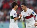 Cristiano Ronaldo of Portugal speaks with Joao Felix of Portugal during the FIFA World Cup Qatar 2022 quarter final match between Morocco/Spain and Portugal/Switzerland at Al Thumama Stadium on December 10, 2022 in Doha, Qatar. (Photo by Justin Setterfield/Getty Images)