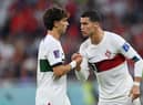 Cristiano Ronaldo of Portugal speaks with Joao Felix of Portugal during the FIFA World Cup Qatar 2022 quarter final match between Morocco/Spain and Portugal/Switzerland at Al Thumama Stadium on December 10, 2022 in Doha, Qatar. (Photo by Justin Setterfield/Getty Images)