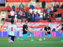 England's midfielder Jude Bellingham (L), Austria's defender Stefan Posch (2L), Austria's midfielder Xaver Schlager (2R) and Austria's striker Marcel Sabitzer take the knee in support of the No Room For Racism campaign ahead of the international friendly football match between England and Austria at the Riverside Stadium.