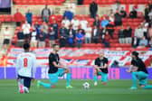 England's midfielder Jude Bellingham (L), Austria's defender Stefan Posch (2L), Austria's midfielder Xaver Schlager (2R) and Austria's striker Marcel Sabitzer take the knee in support of the No Room For Racism campaign ahead of the international friendly football match between England and Austria at the Riverside Stadium.