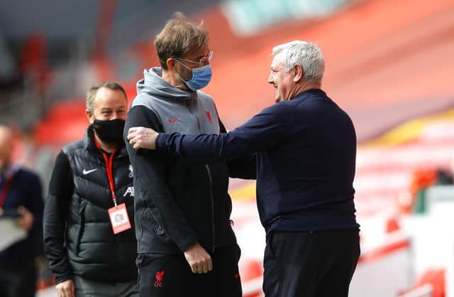 Juergen Klopp, Manager of Liverpool speaks to Steve Bruce, Manager of Newcastle United prior to the Premier League match between Liverpool and Newcastle United at Anfield on April 24, 2021 in Liverpool, England.
