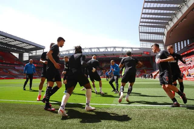 The Newcastle United team warm up prior to the Premier League match between Liverpool and Newcastle United at Anfield on April 24, 2021 in Liverpool, England.