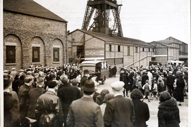 Crowds waiting for news at the Markham coal mine in 1938,  after the mining disaster. The Bishop of Derby prayed with the rescued miners, and the widows and daughters of those who lost their lives, at the pit-head. (Photo by Fox Photos/Hulton Archive/Getty Images)