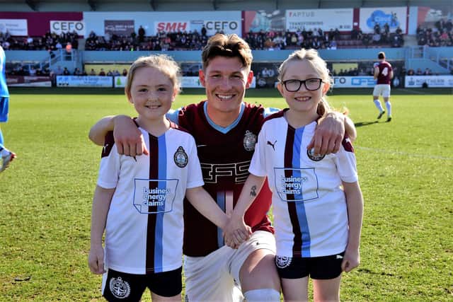 South Shields player Dillon Morse with two Epinay pupils.