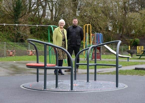 Councillor Joan Atkinson is pictured with Paul Fairley, of Play Fitness, overseeing the installation of a new level roundabout in the play area at Cleadon Recreation Ground.