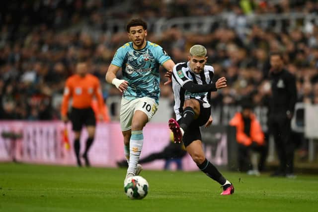 Bruno Guimaraes of Newcastle United shoots under pressure from Che Adams of Southampton during the Carabao Cup Semi Final 2nd Leg match between Newcastle United and Southampton at St James' Park on January 31, 2023 in Newcastle upon Tyne, England. (Photo by Gareth Copley/Getty Images)