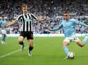 Phil Foden of Manchester City attempts to cross the ball past Emil Krafth of Newcastle United during the Premier League match between Newcastle United and Manchester City at St. James Park on August 21, 2022 in Newcastle upon Tyne, England. (Photo by Clive Brunskill/Getty Images)
