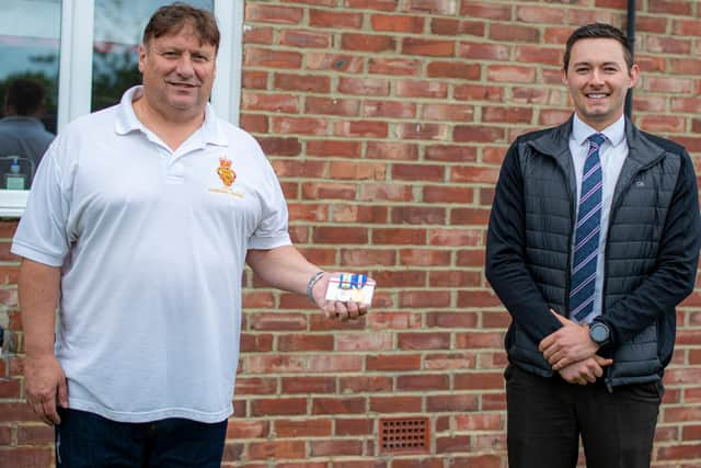 Anthony Paterson (left) with Detective Sergeant Chris Raper-Smith after the medals were returned.