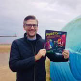 Sunderland author David Crosby with a copy of his new Pirates vs. Monsters picture book.