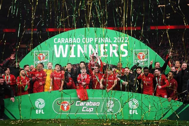 Jordan Henderson of Liverpool lifts the Carabao Cup trophy following victory in the Carabao Cup Final match between Chelsea and Liverpool at Wembley Stadium on February 27, 2022. (Photo by Shaun Botterill/Getty Images)