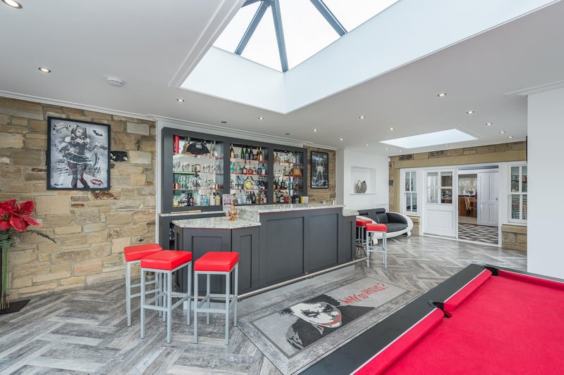 The bar/games room with built in bar and space for pool table, skylights window and folding doors to the rear.