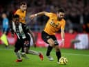 Joao Moutinho of Wolverhampton Wanderers in action with Christian Atsu of Newcastle United.