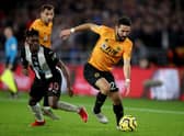Joao Moutinho of Wolverhampton Wanderers in action with Christian Atsu of Newcastle United.