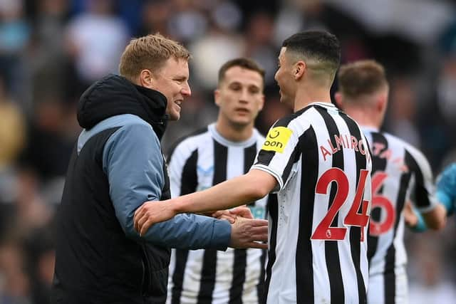 Newcastle United head coach Eddie Howe embraces midfielder Miguel Almiron.