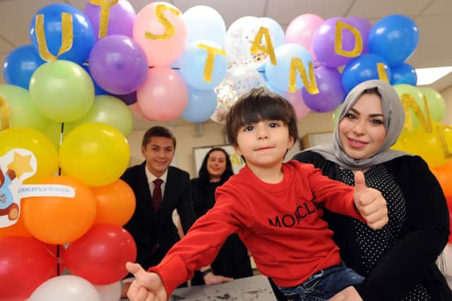 Mrs Huda Alnajjar and her son Ryan with Cllr Ellison and nursery manager Laura Brennan looking on.