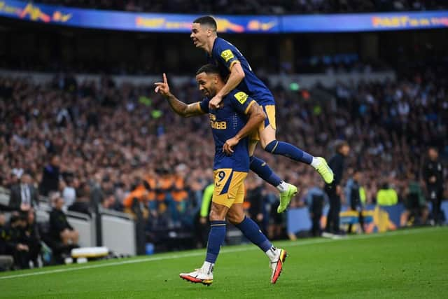 Callum Wilson celebrates with Miguel Almiron of Newcastle United after scoring their team's first goal during the Premier League match between Tottenham Hotspur and Newcastle United at Tottenham Hotspur Stadium on October 23, 2022 in London, England. (Photo by Justin Setterfield/Getty Images)