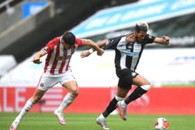 John Egan of Sheffield United pulls the shirt of Joelinton of Newcastle United which leads to the second yellow card.