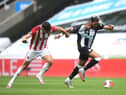 John Egan of Sheffield United pulls the shirt of Joelinton of Newcastle United which leads to the second yellow card.