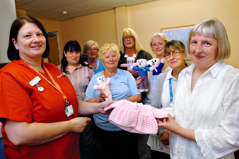 Sunderland Royal Hospital Nursery Nurse Sue Harvey accepts the gifts of knitwear from Maureen Davidson and members of the Knit and Natter group from Sunderland MIND. Does this bring back lovely memories?