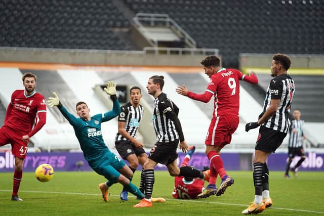 Liverpool's Brazilian midfielder Roberto Firmino (2L) shoots but fails to score during the English Premier League football match between Newcastle United and Liverpool at St James' Park in Newcastle-upon-Tyne, north east England on December 30, 2020.