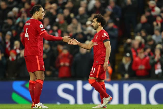 Mohamed Salah (R) of Liverpool celebrates with teammate Virgil van Dijk after scoring their side's first goal from the penalty spot during the Premier League match between Liverpool and Aston Villa at Anfield on December 11, 2021 in Liverpool, England. (Photo by Clive Brunskill/Getty Images)
