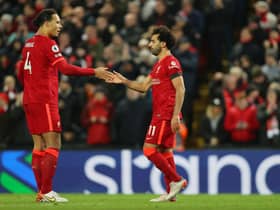Mohamed Salah (R) of Liverpool celebrates with teammate Virgil van Dijk after scoring their side's first goal from the penalty spot during the Premier League match between Liverpool and Aston Villa at Anfield on December 11, 2021 in Liverpool, England. (Photo by Clive Brunskill/Getty Images)