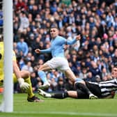 Phil Foden of Manchester City scores the team's first goal during the Premier League match between Manchester City and Newcastle United at Etihad Stadium on March 04, 2023 in Manchester, England. (Photo by Laurence Griffiths/Getty Images)
