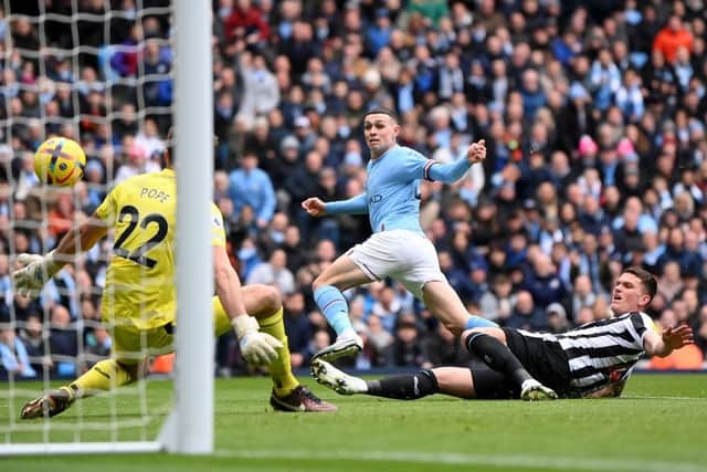 Phil Foden of Manchester City scores the team's first goal during the Premier League match between Manchester City and Newcastle United at Etihad Stadium on March 04, 2023 in Manchester, England. (Photo by Laurence Griffiths/Getty Images)