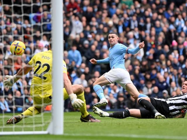 Phil Foden of Manchester City scores the team's first goal during the Premier League match between Manchester City and Newcastle United at Etihad Stadium on March 04, 2023 in Manchester, England. (Photo by Laurence Griffiths/Getty Images)