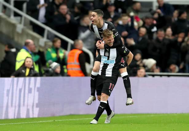 NEWCASTLE UPON TYNE, ENGLAND - JANUARY 14: Matt Ritchie of Newcastle United celebrates his sides first goal with Miguel Almiron after a Eoghan O'Connell of Rochdale (not pictured) own goal during the FA Cup Third Round Replay match between Newcastle United and Rochdale at St. James Park on January 14, 2020 in Newcastle upon Tyne, England. (Photo by Ian MacNicol/Getty Images)