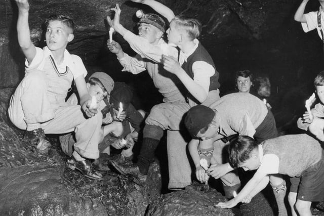 A party of school boys on holiday camp exploring the newly-discovered passage at Bagshwe Cavern, Bradwell, in 1936.