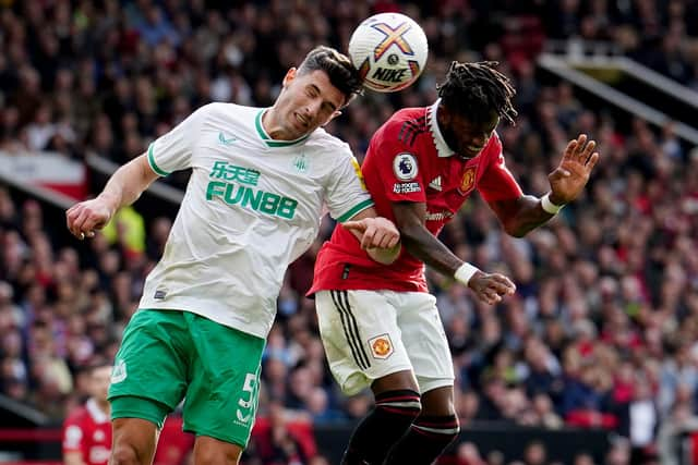 Newcastle United's Fabian Schar battles with Manchester United's Fred at Old Trafford.