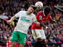 Newcastle United's Fabian Schar battles with Manchester United's Fred at Old Trafford.