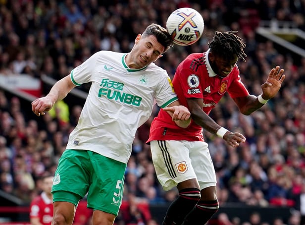 Newcastle United's Fabian Schar battles with Manchester United's Fred at Old Trafford.
