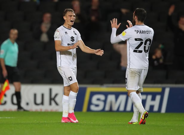 MILTON KEYNES, ENGLAND - SEPTEMBER 28: Scott Twine of Milton Keynes Dons  celebrates with Troy Parrott after scoring his and his sides second goal during the Sky Bet League One match between Milton Keynes Dons and Fleetwood Town at Stadium mk on September 28, 2021 in Milton Keynes, England. (Photo by Pete Norton/Getty Images)